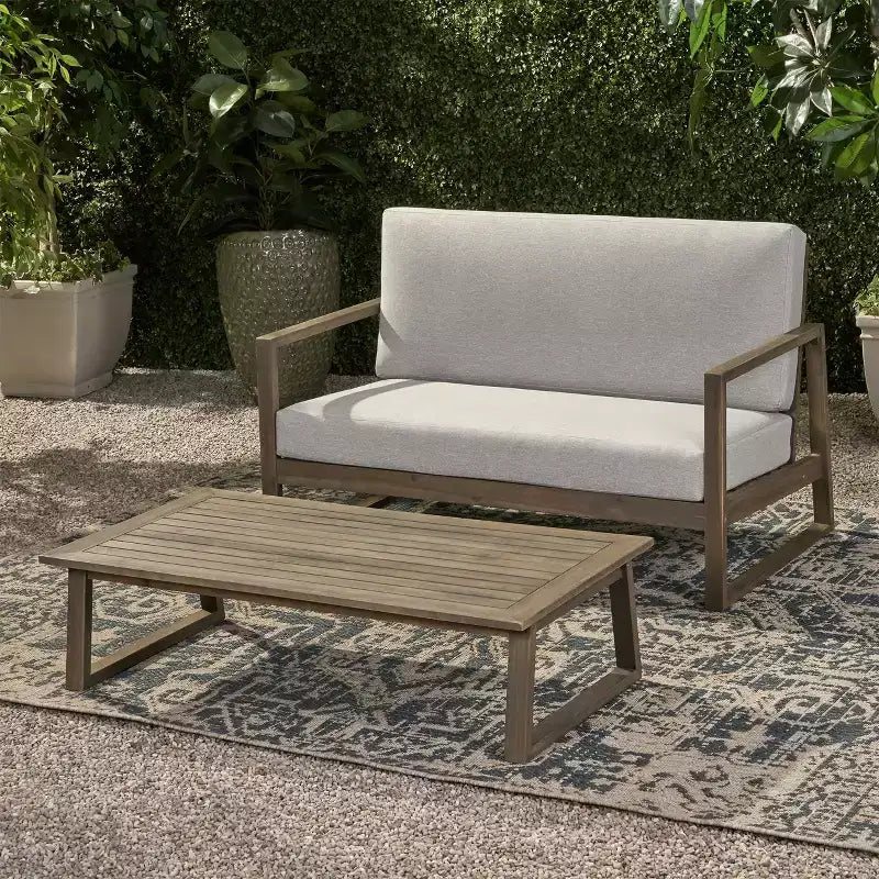 Conjunto de sofá de dos plazas y mesa de centro de madera de acacia para exterior Hazel de Christopher Knight Home, con cojines